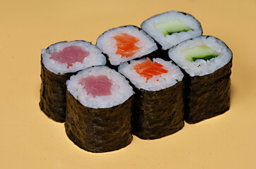 traditional japanese food rolls isolated on a yellow background