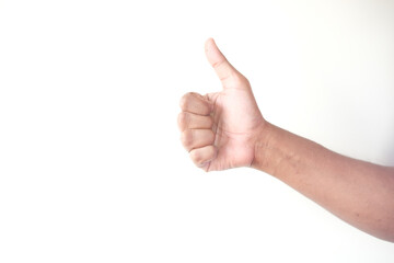 man hand showing a thumb-up on white wall 