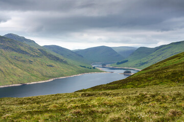 Loch Daimh with the mountain summits of Stuc an Lochain, Meallan Odhar to the left and Sron A Choire Chnapanaich in the distance in the Scottish Highlands, UK landscapes.