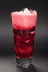 cherry-colored cocktail on a black background