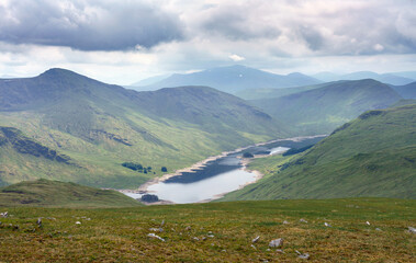 Loch Daimh with the mountain summits of Creag an Fheadain to the left and Sron A Choire Chnapanaich in the distance in the Scottish Highlands, UK landscapes.