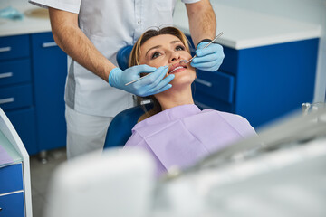 Obraz premium Teeth of a female in dentist chair under stomatological check