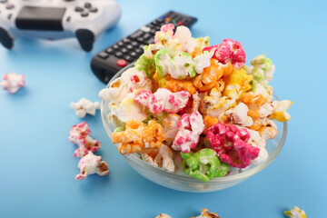 popcorn, joystick and Tv remote on table 