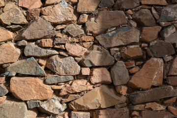 Stone wall of an old house in a village