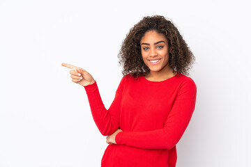 Young African American woman isolated on background pointing finger to the side