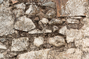 Stone wall of an old house in a village