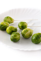 Set of brussel sprouts with lollipop sticks isolated on white background