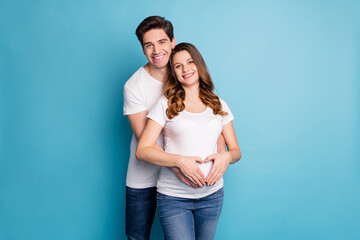 Photo of young cheerful happy positive smiling family husband hug wife touching belly isolated on blue color background