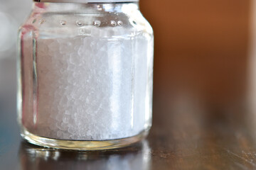 A close-up view of white salt jar.