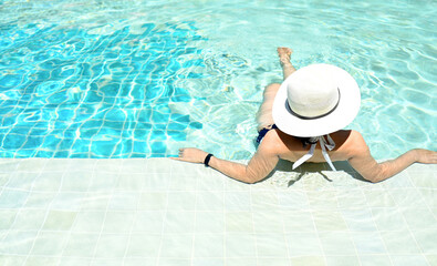 Girl relaxing in pool summer Tropical beach lifestyle.