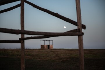 Rural scene of abandoned building in the night with moonlight.