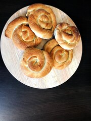 Meat Twist Pie on the wooden. A traditional Turkish tepsi boregi, rulo borek. Greek meat pie with feta, goat, spinach or meat with black background on wooden floor