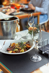 A romantic dinner in the summer on the deck of the ship at the bottom m with two glasses of white...