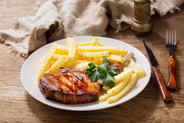 plate of grilled pork with french fries