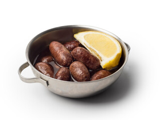 Lebanese starters of Makanek meat marinated, sausages fried in a metal pan isolated on white, clipping path included.