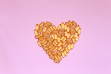 The heart laid out from the vitamin lies on the background. Pills in the form of the word love are on the table. High quality photo