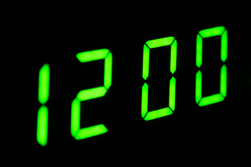 Electronic digital clock close-up. The clock is 12 o'clock. The clock can be used as an alarm clock. Modern technologies.