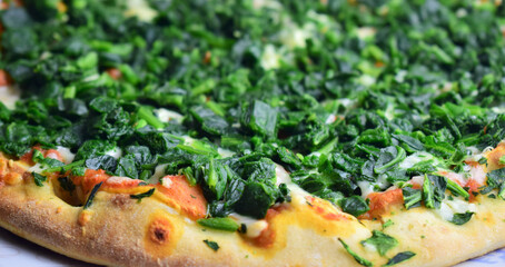 Slice of pizza with vegetables, spinach