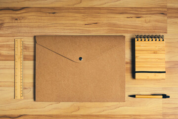 Wooden notebook and bamboo pen, recicled paper folder: sustainable office supplies for a low impact on environment