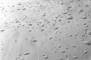 Drops of water or rain on a light smooth surface with reflection. Wet surface texture and pattern