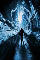 Man exploring an amazing glacial ice cave
