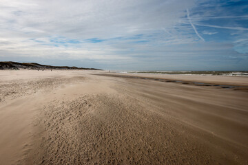 The North Sea beach on a sunny stormy winter day with drifting beach sand near the slufter valley...