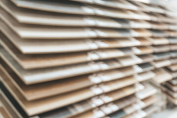 Samples of wooden floor laminate and parquet in the store blurred background. Blurred wooden floor background.