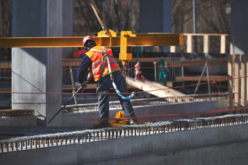 Construction site worker with safety harness hook