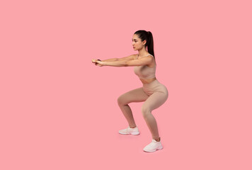 Fototapeta na wymiar Confident Young Lady Doing Deep Squat Exercise