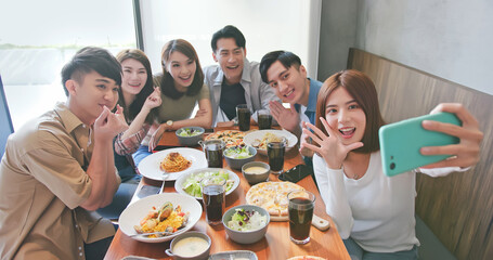 friends take selfie in restaurant