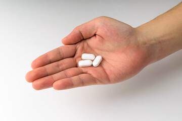 White pills on a white background