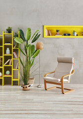 Modern grey room home interior style with stone wall concept, single rocking chair, yellow bookshelf and niche, wicker vase of plant.