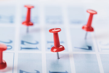 Calendar page for 2021, a month marked with an important date with a pin. chronology, time, concept