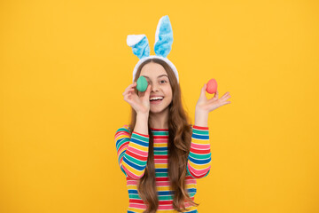 happy easter. childhood happiness. child in rabbit ears hold painted eggs. time for fun.