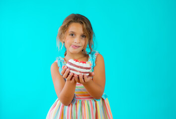 Cute adorable little girl celebrating birthday standing isolated over green background