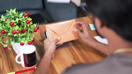 Shoulder shot of young man receiving prank latter - Concept of April fools day prank showing by sending surprise letter, after opening mentioned april fool in the latter