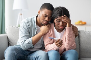 Upset black couple with negative pregnancy test at home