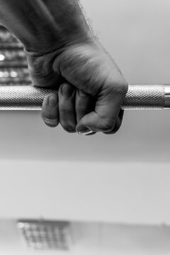 Hand Holding Barbell