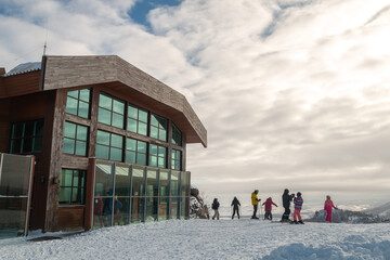 Upper plateau in the ski resort of Bannoye, Bashkortostan, Russia. Snowboarders and skiers relax on the mountain.