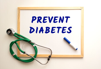 The text PREVENT DIABETES is written on a white office board. Nearby is a stethoscope.