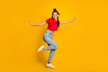 Fototapeta na wymiar Full length body size profile side view of attractive thin cheerful girl jumping having fun isolated bright yellow color background