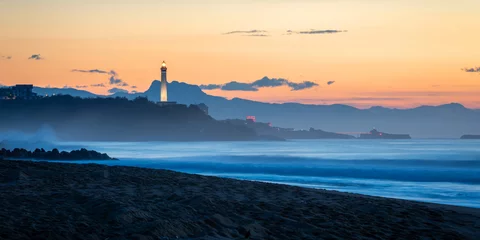 Wandcirkels aluminium The Biarritz lighthouse at sunset,Atlantic ocean and beach in the foreground, in France © Thomas Dutour