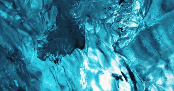 Deeply blue ice forming glacial ice cave slowly melting down in Iceland in winter 4K