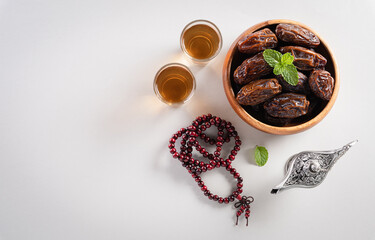 Table top view image of decoration Ramadan Kareem,  dates fruit, aladdin lamp and rosary beads on gray  background. Flat lay with copy space.