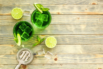 Green Mojito cocktail with bar utensils and ingredients. Top view