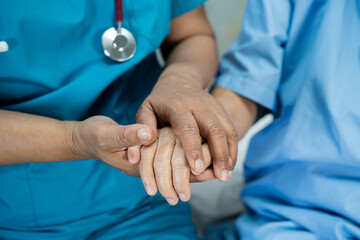 Doctor holding hands Asian senior or elderly old lady woman patient with love, care, encourage and...