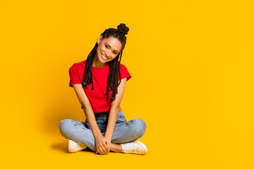 Portrait of pretty cheerful girl sitting in lotus pose wearing cozy casual clothes copy space isolated on bright yellow color background