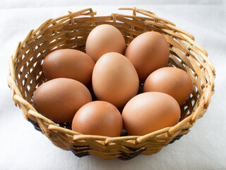 A group of eggs in a wicker basket