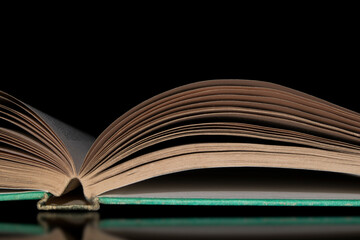 Open book with book pages visible on black background
