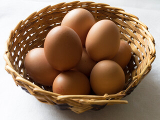 A group of eggs in a wicker basket